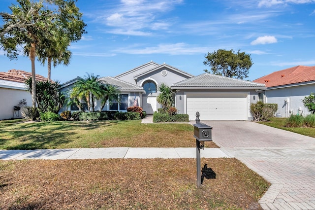 view of front of home with a garage and a front yard