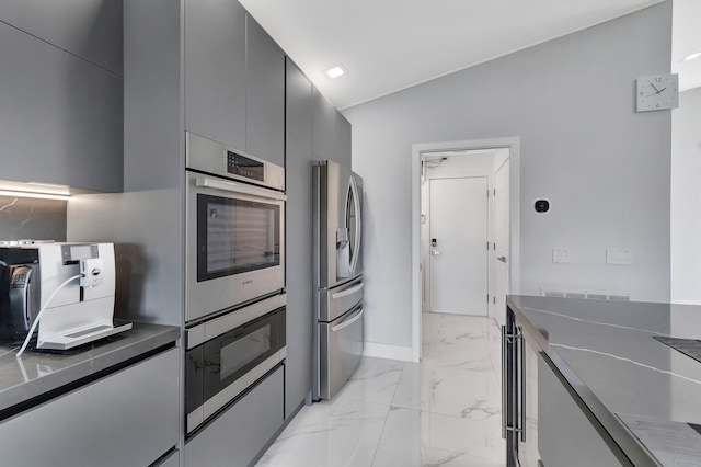 kitchen featuring stainless steel fridge with ice dispenser and vaulted ceiling