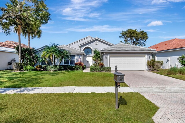 single story home with a garage and a front yard