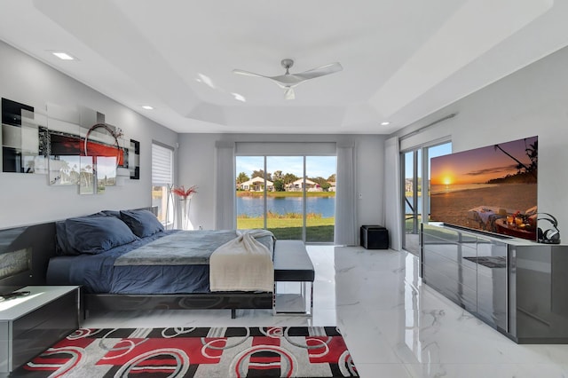 bedroom featuring a raised ceiling, access to exterior, and ceiling fan