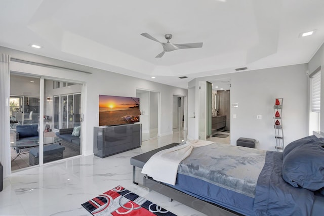 bedroom with ceiling fan and a tray ceiling