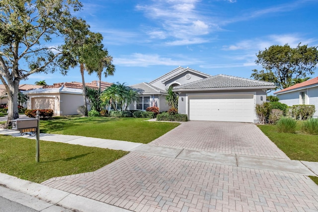 ranch-style house featuring a garage and a front yard