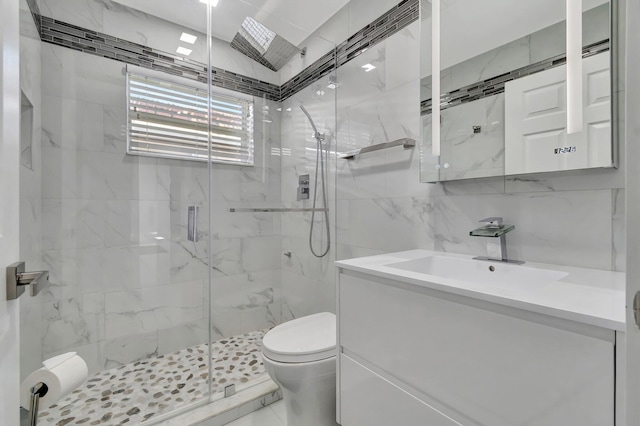 bathroom with a shower with shower door, tile walls, decorative backsplash, vanity, and toilet