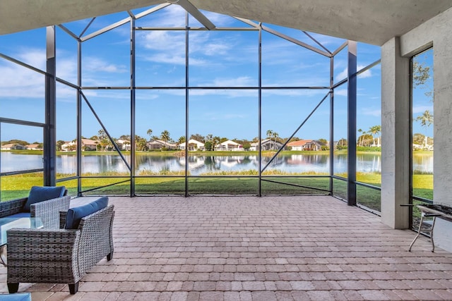 view of patio / terrace with glass enclosure and a water view