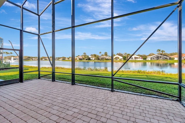 unfurnished sunroom featuring a water view