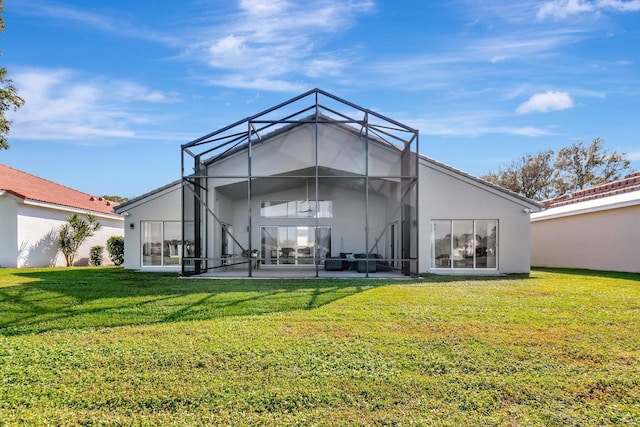 rear view of property with a patio, a yard, and glass enclosure