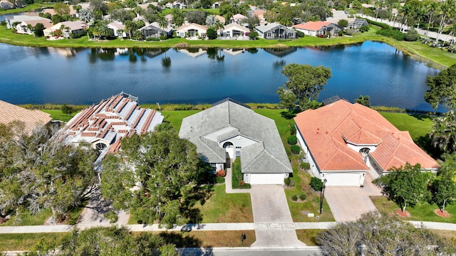 birds eye view of property with a water view and a residential view
