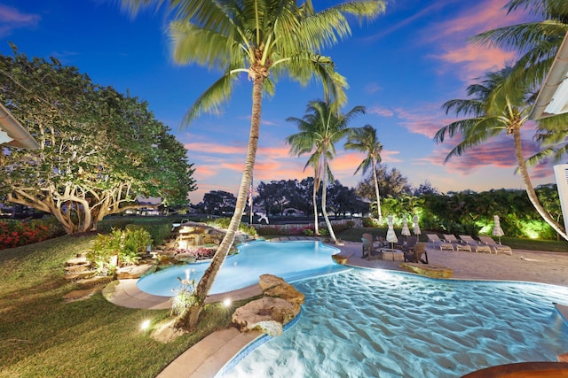 pool at dusk with a patio