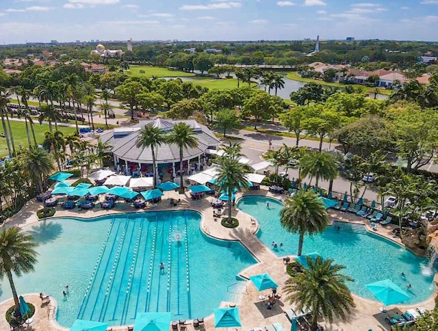 view of swimming pool featuring a patio and a water view