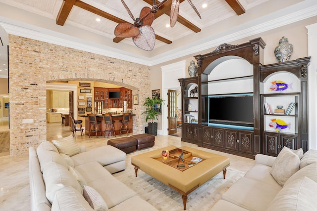 living room with coffered ceiling, ceiling fan, beam ceiling, and a high ceiling