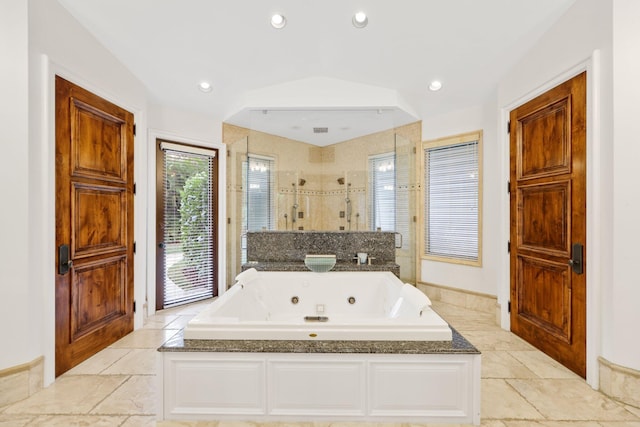 bathroom featuring vaulted ceiling and shower with separate bathtub