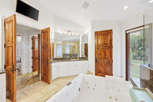 bathroom with hardwood / wood-style flooring, vanity, shower with separate bathtub, and vaulted ceiling