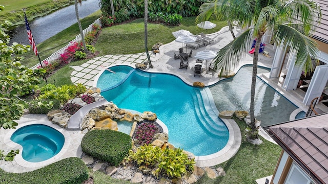 view of swimming pool featuring a yard, a patio area, and a water slide