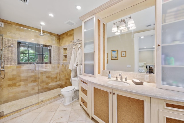 bathroom featuring vanity, a shower with door, and toilet