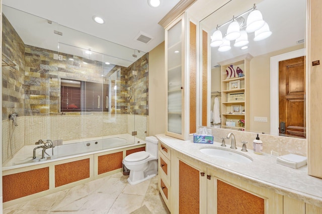 full bathroom with vanity, tiled shower / bath, and toilet