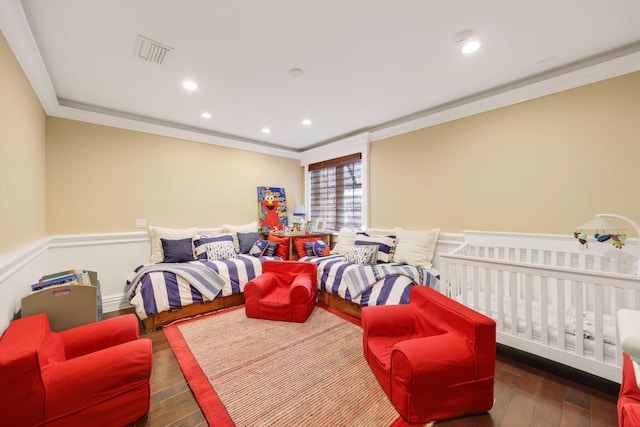 bedroom with ornamental molding and dark wood-type flooring