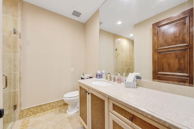 bathroom featuring vanity, walk in shower, and toilet