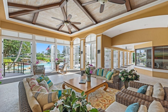 sunroom with lofted ceiling with beams, ceiling fan, a water view, and wood ceiling