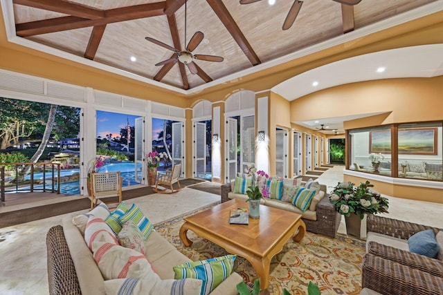 living room featuring ceiling fan, wood ceiling, beamed ceiling, and a high ceiling