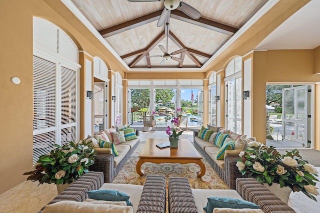 sunroom with plenty of natural light, vaulted ceiling with beams, wooden ceiling, and ceiling fan