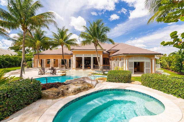 view of pool with an in ground hot tub and a patio