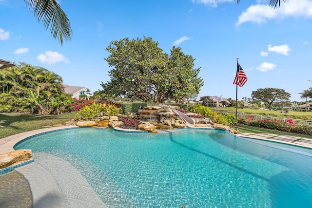 view of swimming pool with a water slide