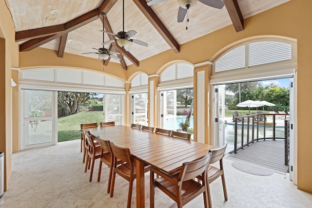 sunroom with wood ceiling, a water view, a healthy amount of sunlight, and lofted ceiling with beams