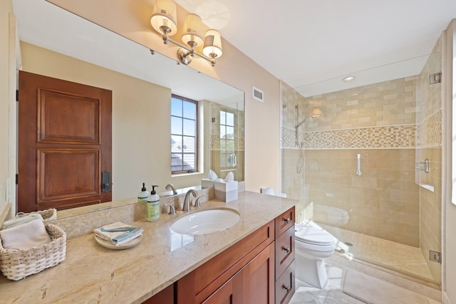 bathroom with vanity, a shower with shower door, and toilet