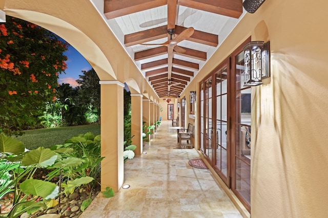 patio terrace at dusk featuring ceiling fan