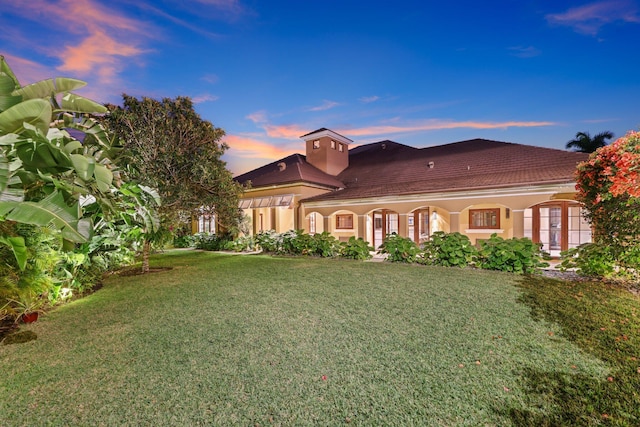 view of front of home with a lawn