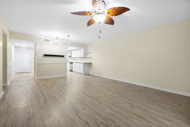 unfurnished living room with ceiling fan and light wood-type flooring