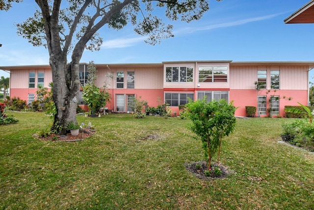 rear view of property with a lawn