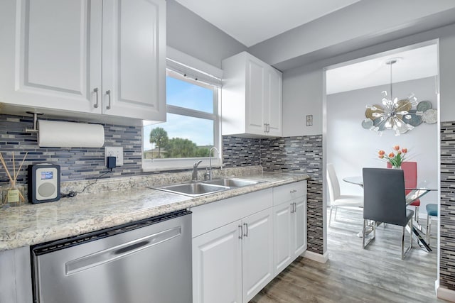 kitchen featuring decorative backsplash, dishwasher, hanging light fixtures, white cabinets, and sink