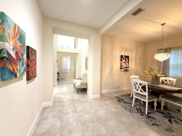 dining space featuring a notable chandelier