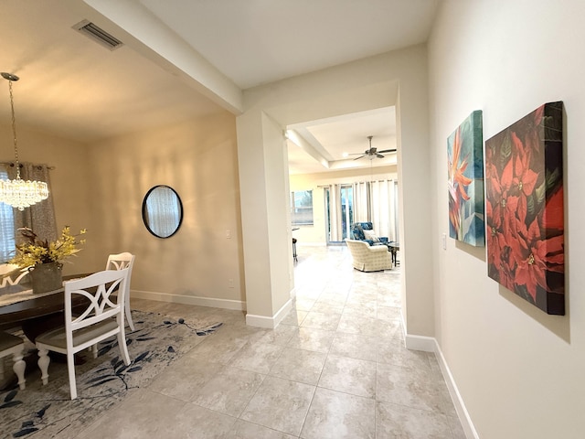 hall featuring an inviting chandelier