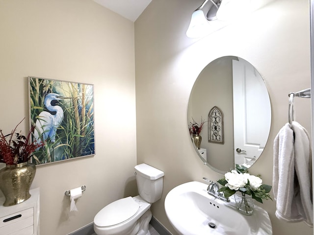 bathroom featuring toilet and sink