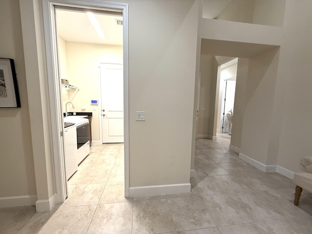 corridor featuring light tile patterned flooring