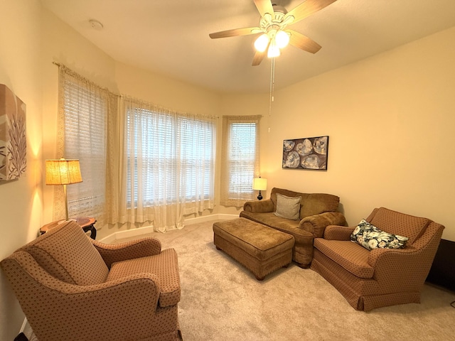 carpeted living room featuring ceiling fan