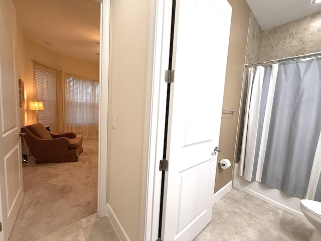 bathroom with toilet and shower / tub combo with curtain