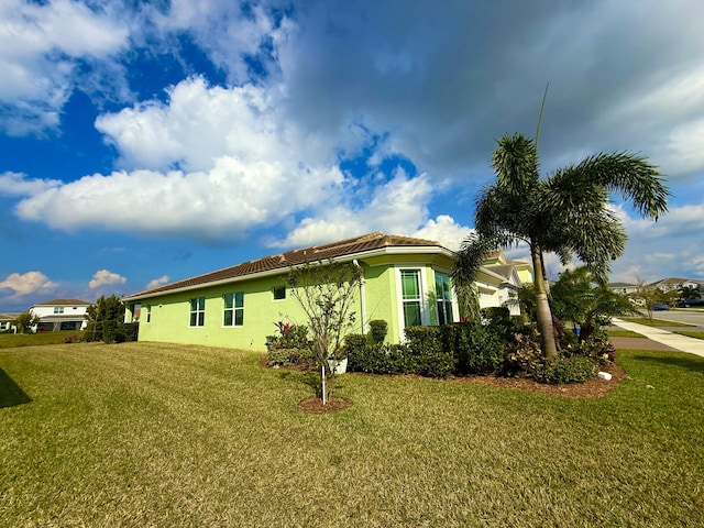 view of property exterior with a lawn