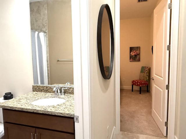 bathroom featuring vanity and toilet