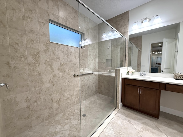 bathroom with vanity, a shower with shower door, and tile patterned flooring