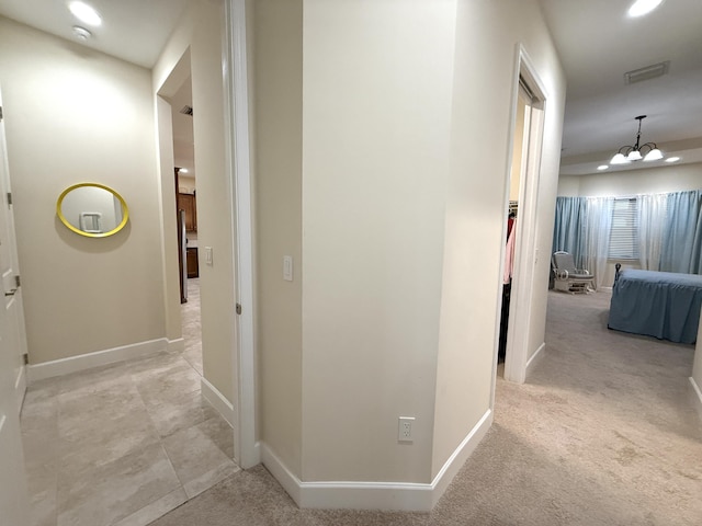 hallway with light colored carpet