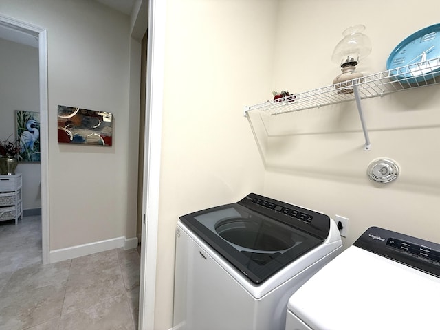 laundry area with light tile patterned floors and independent washer and dryer