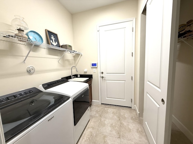 laundry area with separate washer and dryer, light tile patterned floors, and sink