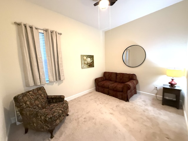 living area with light carpet and ceiling fan