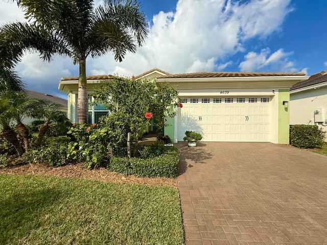 view of front of home with a garage and a front yard