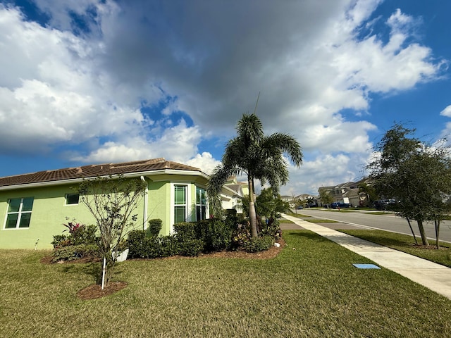 view of side of property with a yard