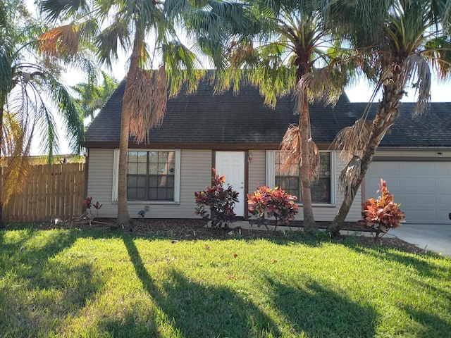 view of front of property with a garage and a front lawn