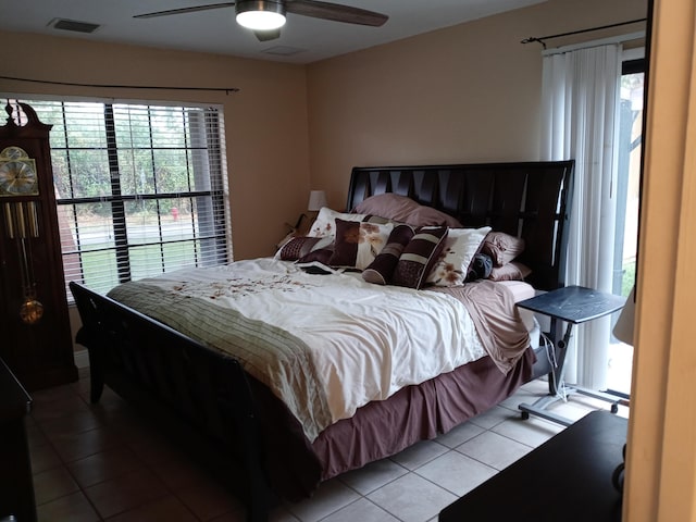 tiled bedroom with ceiling fan